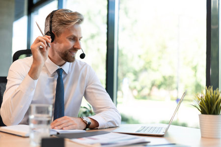 Happy young male customer support executive working in office