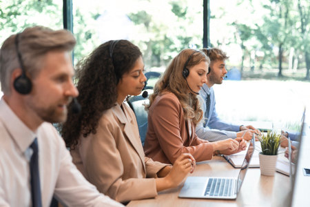 Attractive positive young businesspeople and colleagues in a call center office