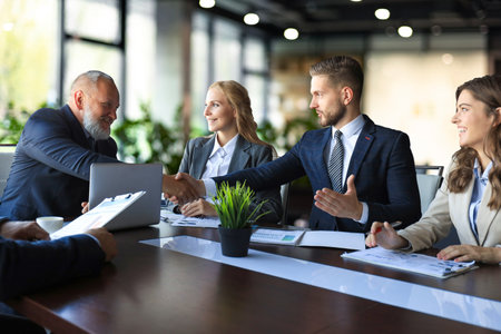 Business people shaking hands, finishing up a meeting.の写真素材