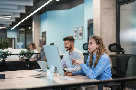 Attractive positive young businesspeople and colleagues in a call center office