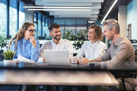 startup business team on meeting in modern bright office interior brainstorming, working on laptop and tablet computerの写真素材