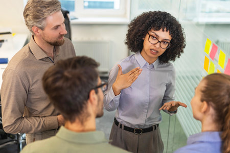 Creative group or business people planning innovation with sticky notes on glass wall. Top viewの写真素材