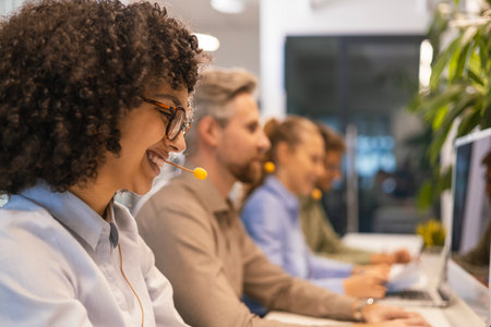 Attractive positive young businesspeople and colleagues in a call center office