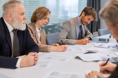 Group of young modern people using modern technologies while working in the modern office.の写真素材