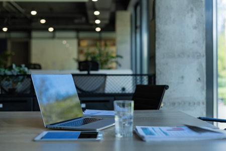 Workplace with laptop and documents, comfortable work table in office.の写真素材