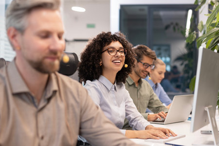 Attractive positive young businesspeople and colleagues in a call center office