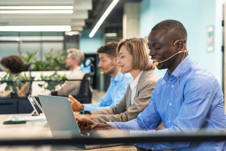 Attractive positive young businesspeople and colleagues in a call center office