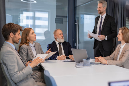 Professional executive businesspeople discuss corporation project planning sit at meeting room, brainstorm financial plan working together in office.の写真素材