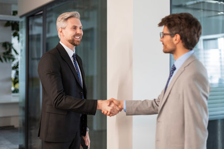 Businessmen shaking hands during a meetingの写真素材