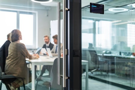 Business office with people casual wear, with blurred bokeh background, view from glass wall.