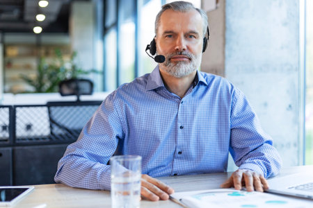 Smiling friendly handsome middle aged male call center operator