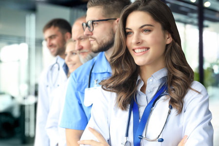 Female doctor with group of happy successful colleaguesの写真素材