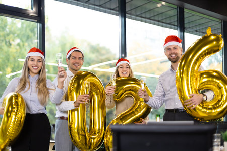 Business people are celebrating holiday in modern office drinking champagne and having fun in...