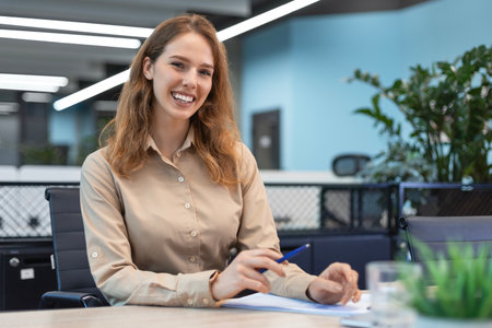 Portrait of happy and successful business woman inside office at workplace, worker smiling and looking at camera.の写真素材