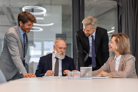Successful businesspeople working in a coworking space discussing strategy and business plan in modern officeの写真素材