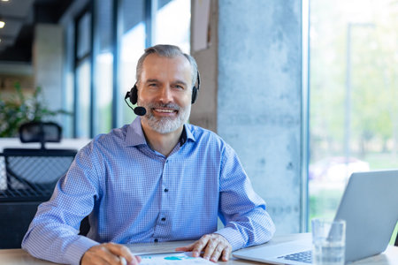 Smiling friendly handsome middle aged male call centre operator