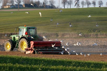 Tractor working on the field. Spring timeの写真素材