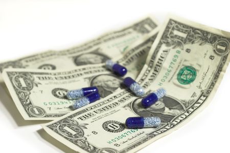 White Blue Pills with One Dollar Bills isolated on white background