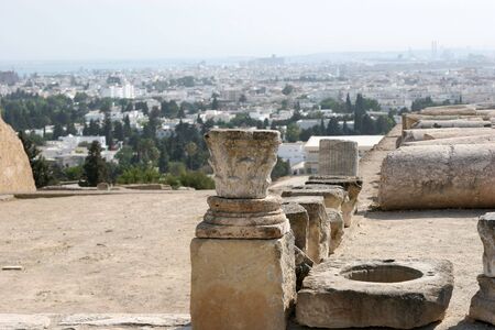 Ancient Roman ruins in Carthage. Tunis in the background の写真素材