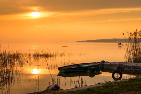 The boat docked on the lake Balaton at sunsetの写真素材