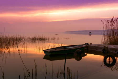 The boat docked on the lake Balaton at sunsetの写真素材