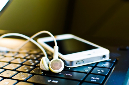 Music digital black laptop and white earphoneの写真素材