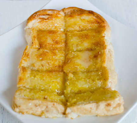 Bread and butter on white plate.の写真素材