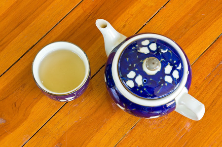 teapot and cup on wood.の写真素材