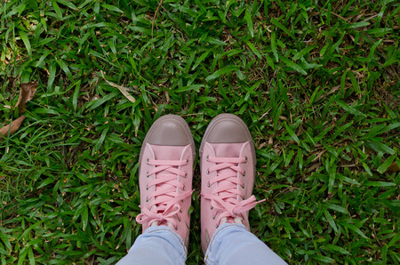 Pink shoes on grass.