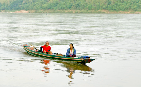 lUANG PRABANG, LAOS - MAY 14, 2014: Villagers in Luang Prabang was traveling by boat on the Mekong river.のeditorial素材