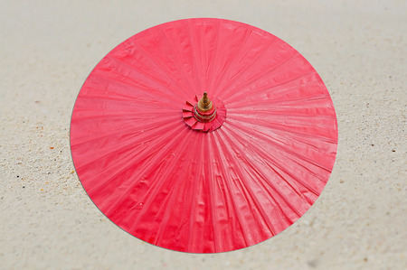 a handmade red, Asian parasol or umbrella isolated on sane background.の写真素材