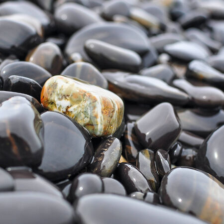 closeup textured pattern of black rocks at Hin Ngam island in Satun, Thailand.の写真素材