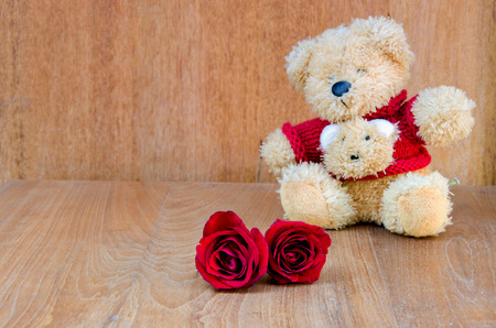 Red rose with teddy bear valentine concept on wooden backgroundの写真素材