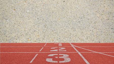 running track number standard red color with sand beach background