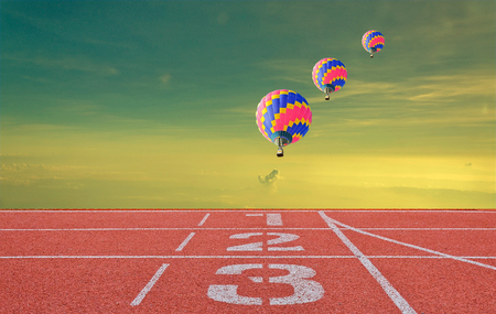 running track number standard red color with three balloons under the skyの写真素材