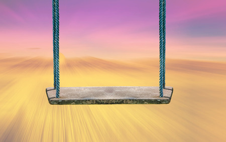 concept of summer traveling with wooden swing and abstract backgroundの写真素材