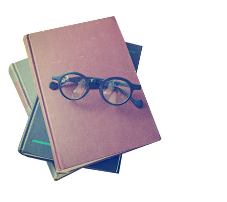 old book and glasses isolated on whiteの写真素材