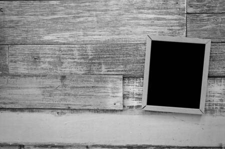 wooden frame hanging on a wooden board.の写真素材