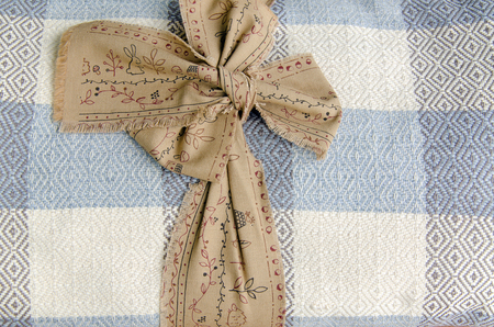 Cotton blanket rolled on wood background