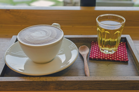 Cup of coffee and tea on wood tableの写真素材
