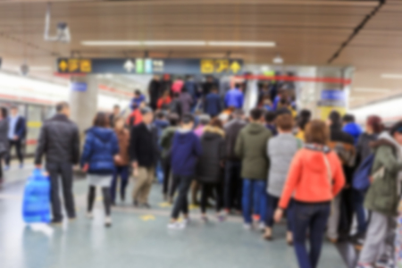 blurred people in subway station.