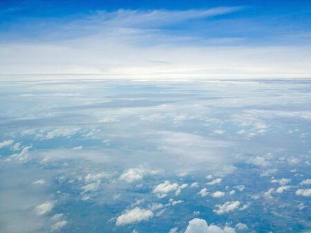 Sky and cloud seen through window of aircraft.