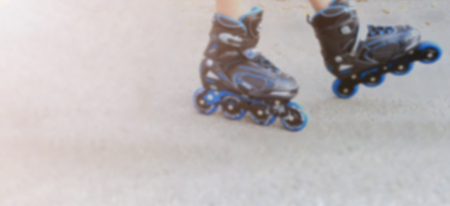 blurred roller skate legs of a child on street.の写真素材