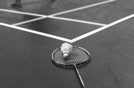 Blurred shuttlecock and racket on badminton floor.の写真素材