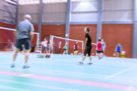 badminton court with burred woman players badminton.の写真素材