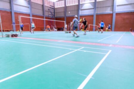 badminton court with burred woman players badminton.の写真素材