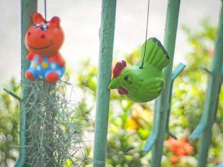 Ceramic doll hanging in garden, selective focusの写真素材