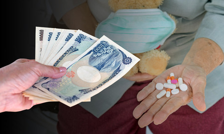 hand woman with Japanese currency yen bank notes on blurred background senior woman holding pill in hand, health care concept.の写真素材