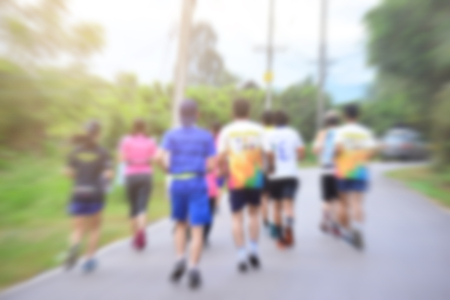 blurred background people running in nature park.の写真素材