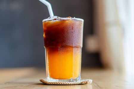 Ice coffee, americano coffee with orange in cafe